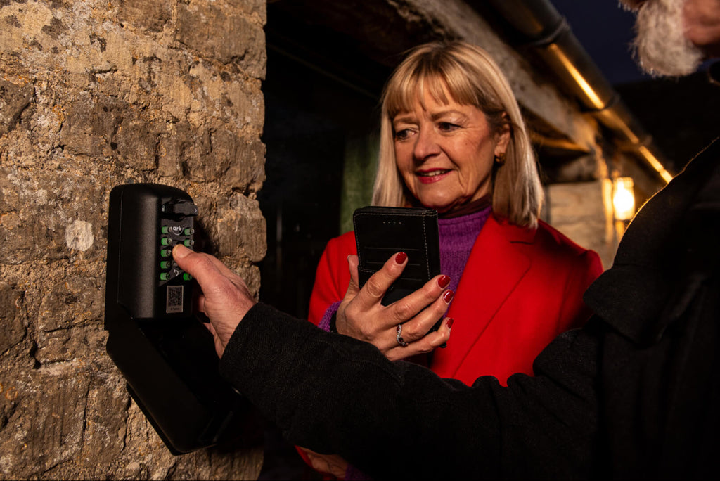 Holiday guests using key safe to access short term rental property airbnb