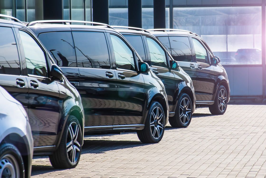 Line of smart black cars outside a car auction house
