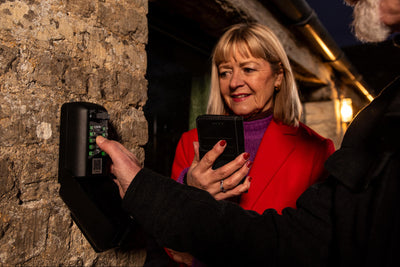 Holiday guests using key safe to access short term rental property airbnb
