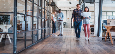 Modern office with staff walking around talking