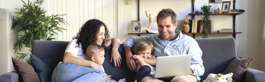 Family of four looking at key safes of the laptop