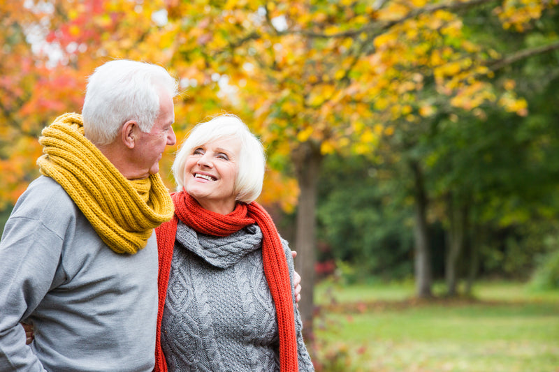 Older couple walking through park