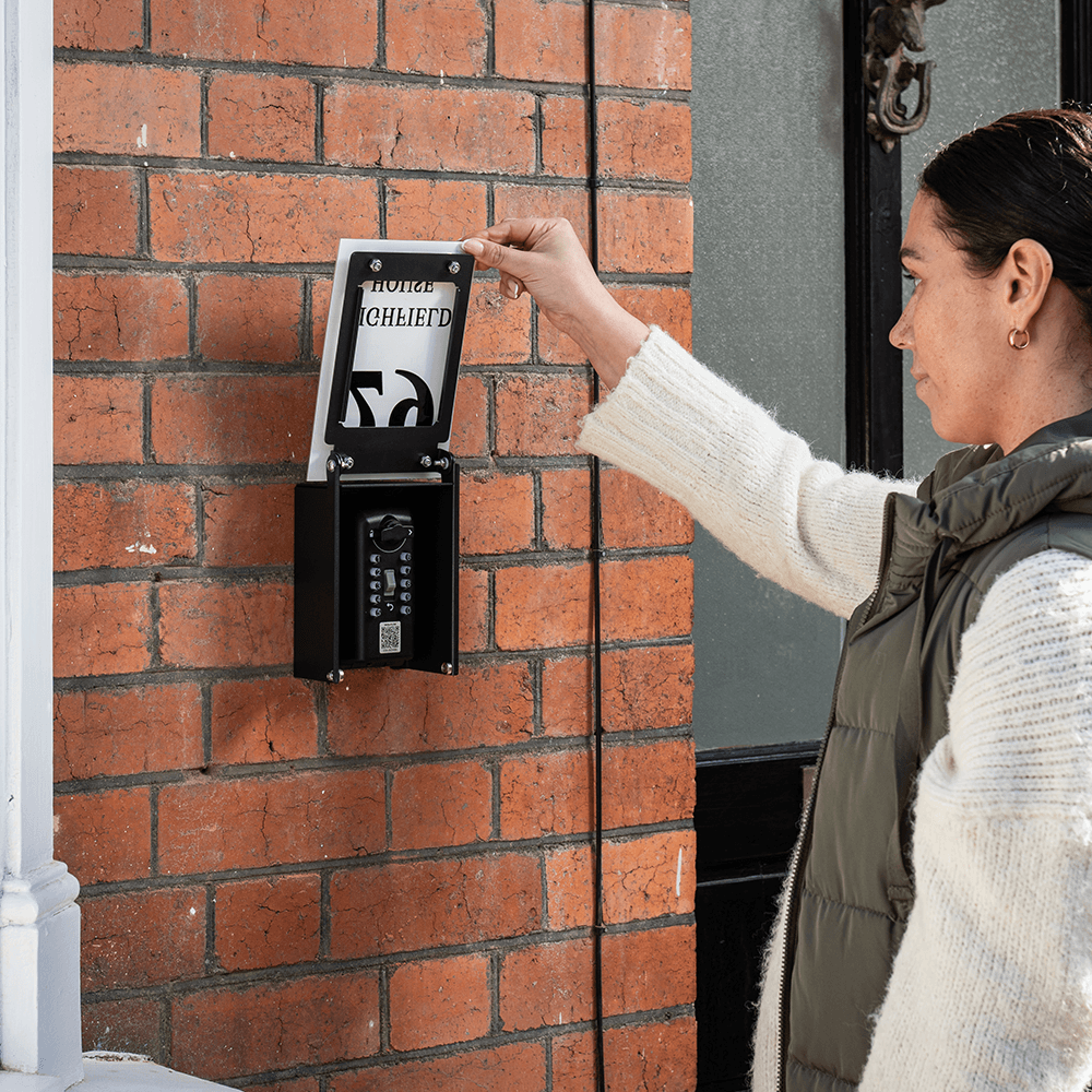 Woman using key safe cover to hide key safe KEYP 