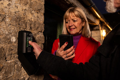 Holiday guests using key safe to access short term rental property airbnb