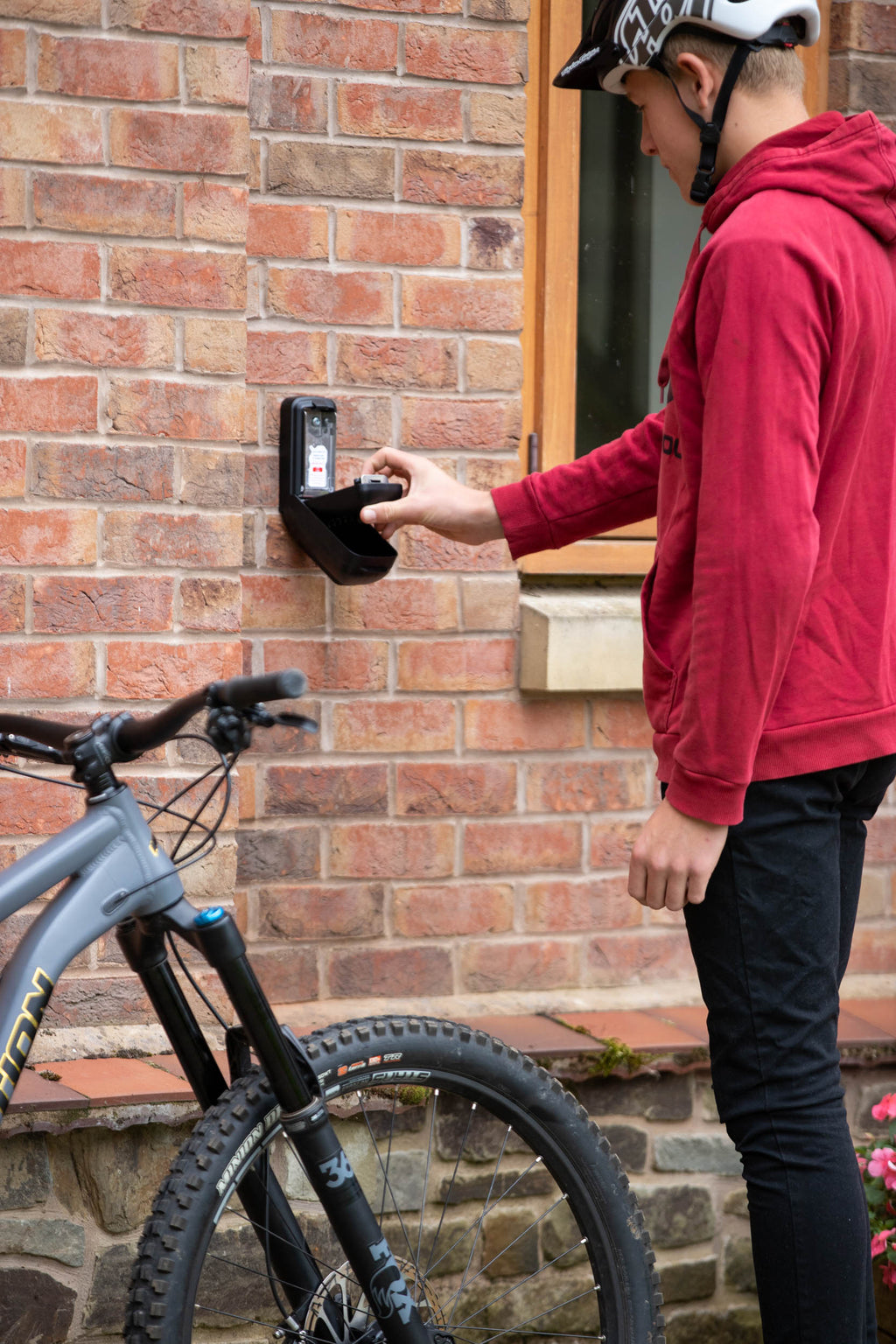 Man with bike using key safe to access home, Key Safe Company
